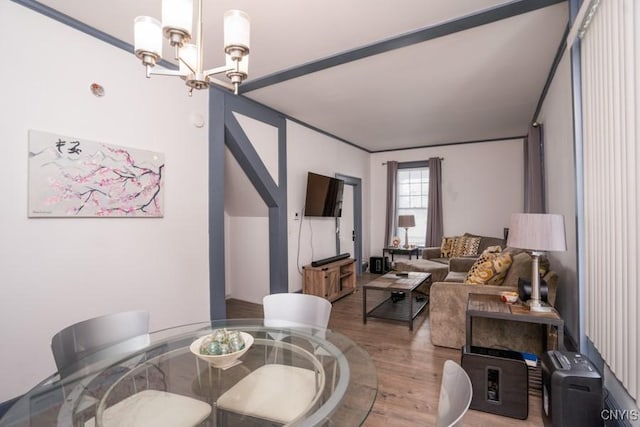 dining space with hardwood / wood-style flooring and a notable chandelier