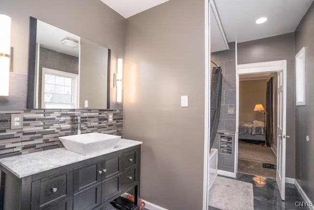 bathroom featuring shower / tub combo with curtain, vanity, and decorative backsplash