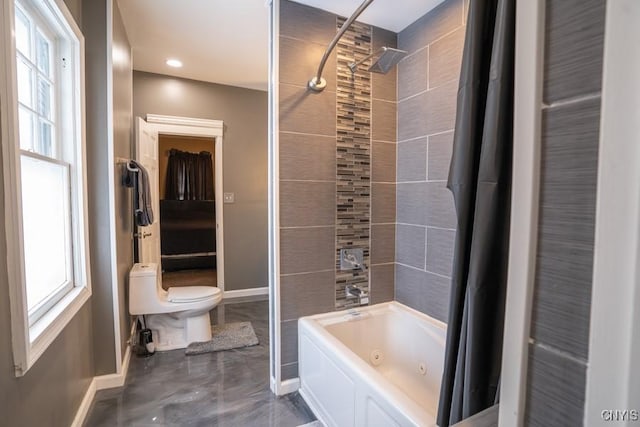 bathroom featuring toilet and shower / tub combo