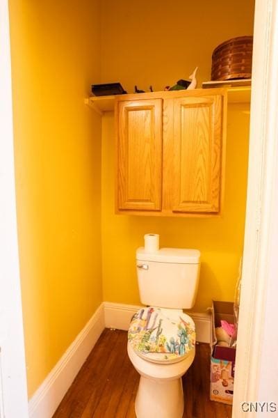 bathroom with hardwood / wood-style floors and toilet