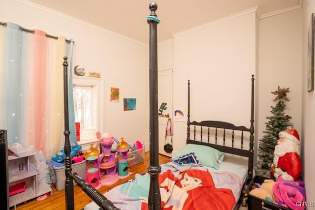 bedroom featuring hardwood / wood-style flooring and crown molding