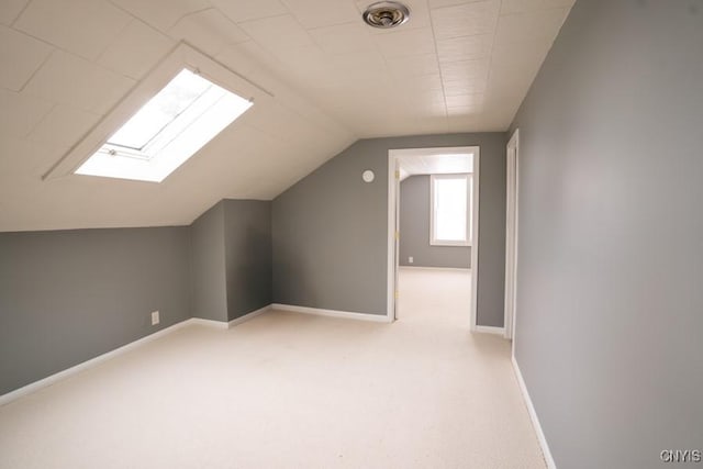 additional living space with lofted ceiling and light colored carpet