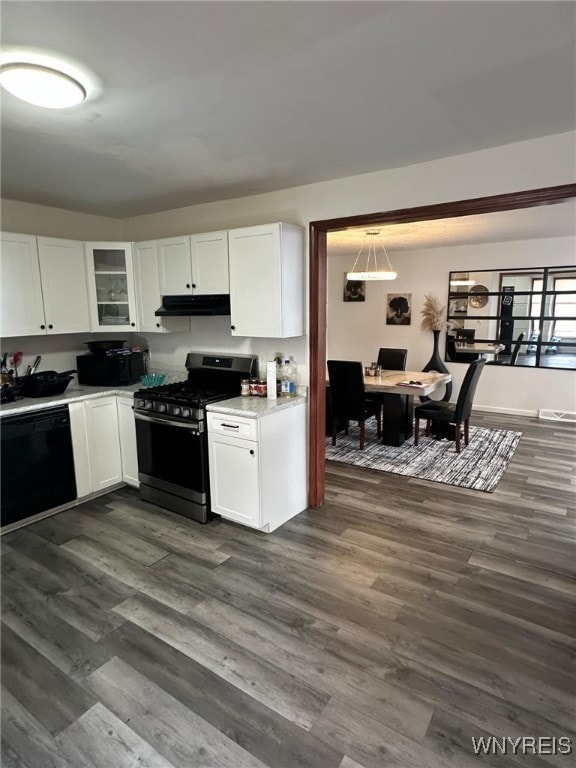 kitchen featuring black dishwasher, white cabinets, dark hardwood / wood-style floors, and stainless steel gas stove