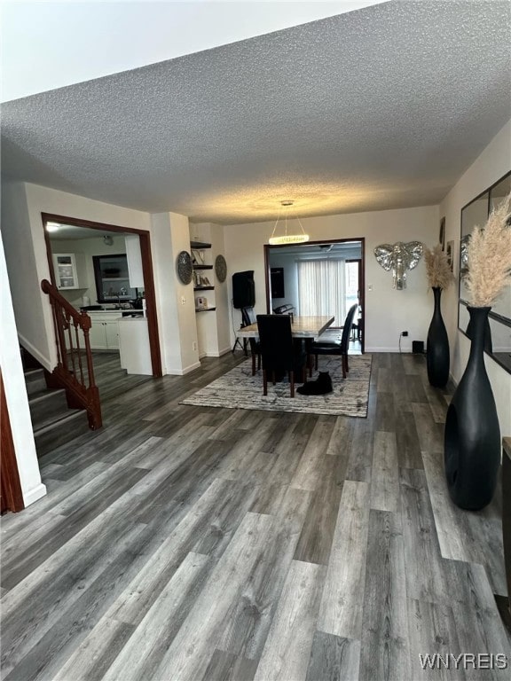 dining space featuring hardwood / wood-style floors and a textured ceiling