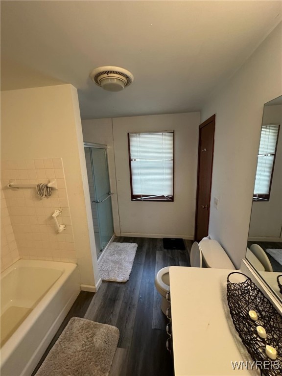 full bathroom with independent shower and bath, vanity, hardwood / wood-style floors, and toilet