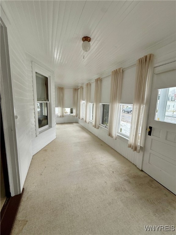 unfurnished sunroom featuring wood ceiling