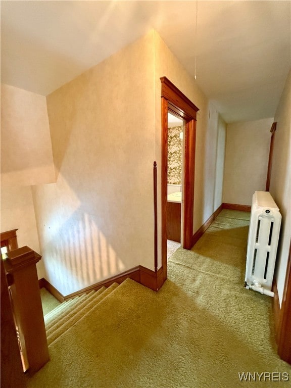 corridor with carpet and radiator heating unit