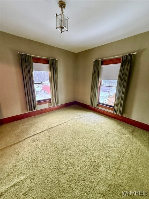 carpeted empty room featuring plenty of natural light