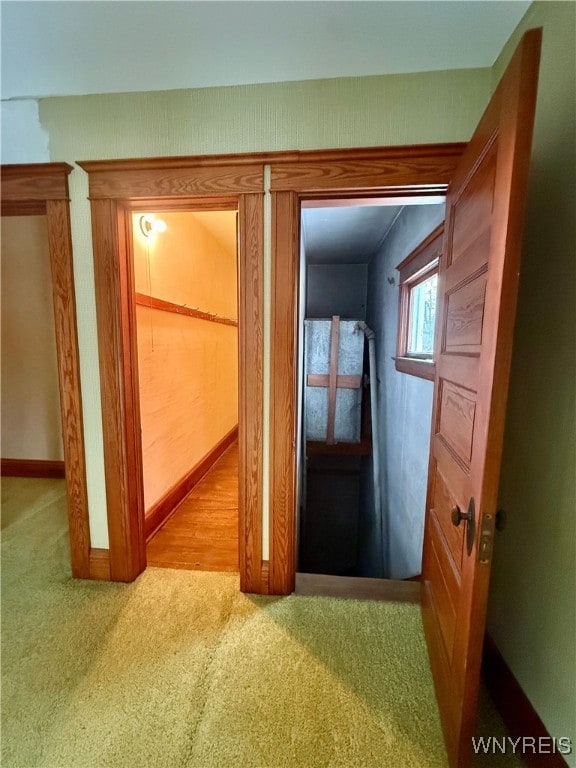 hallway featuring light colored carpet