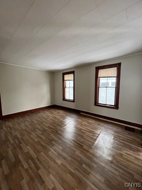 unfurnished room featuring dark wood-type flooring