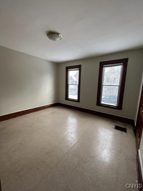 1218 City St, Utica, NY 13502 - unfurnished room featuring tile patterned floors, visible vents, and baseboards