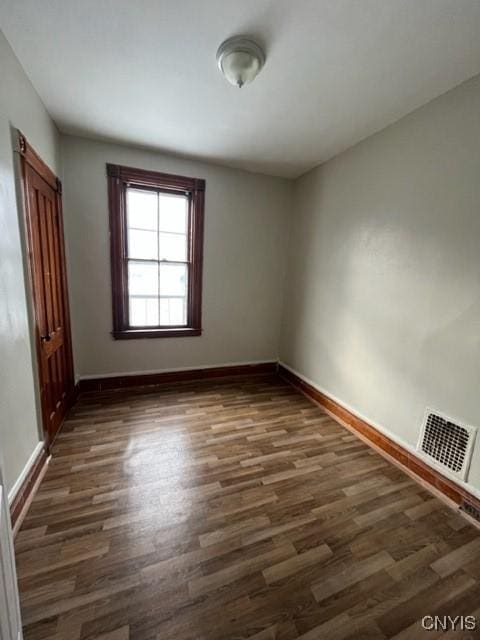 unfurnished room featuring dark hardwood / wood-style floors