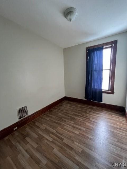 empty room with dark wood-type flooring