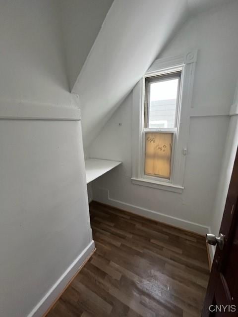 bonus room featuring vaulted ceiling and dark hardwood / wood-style flooring