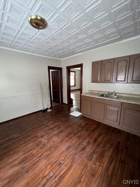 1218 City St, Utica, NY 13502 - kitchen with a sink, an ornate ceiling, crown molding, light countertops, and dark wood-style flooring