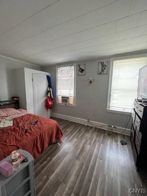 bedroom featuring cooling unit and dark hardwood / wood-style flooring