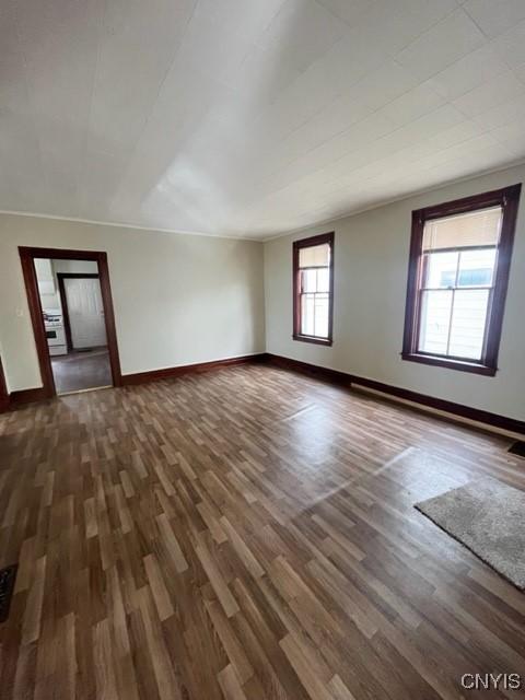 1218 City St, Utica, NY 13502 - empty room with wood finished floors and baseboards