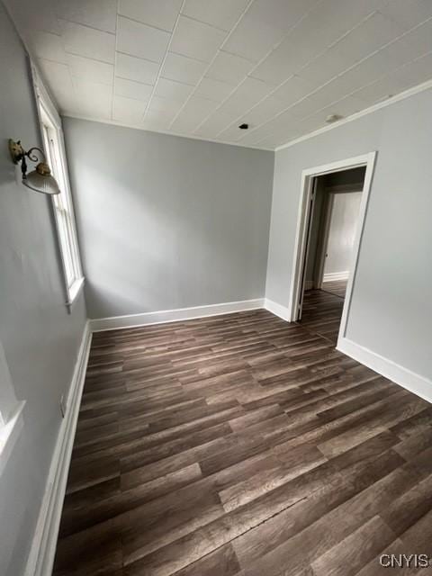 1218 City St, Utica, NY 13502 - unfurnished room featuring baseboards and dark wood-style flooring