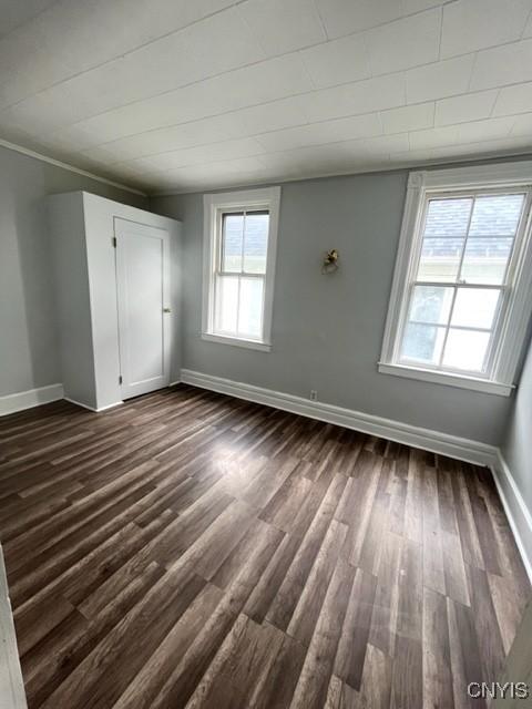 1218 City St, Utica, NY 13502 - empty room featuring baseboards and dark wood finished floors