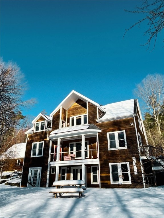 snow covered property featuring a balcony