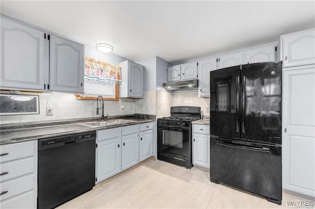 kitchen featuring sink, backsplash, and black appliances