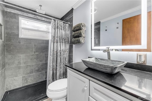 bathroom with vanity, crown molding, toilet, and walk in shower