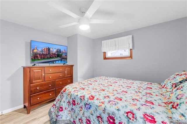 bedroom with ceiling fan and light hardwood / wood-style flooring