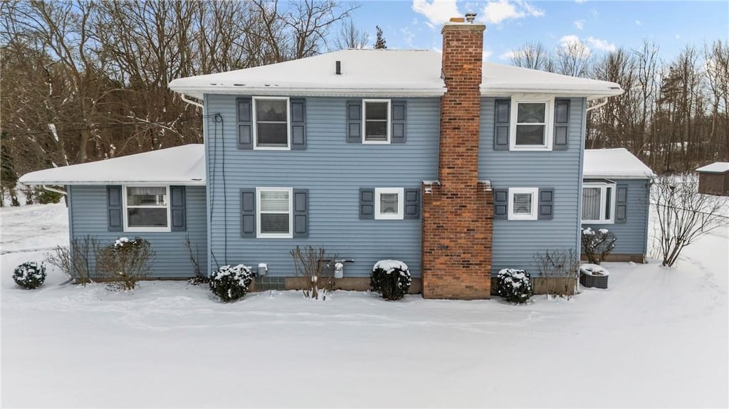 view of snow covered rear of property