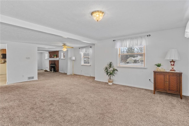 living room with ceiling fan, carpet flooring, and a brick fireplace