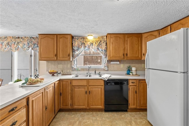 kitchen with sink, black dishwasher, white refrigerator, tasteful backsplash, and a textured ceiling