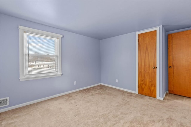 empty room with light colored carpet