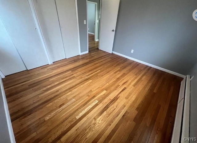 unfurnished bedroom featuring hardwood / wood-style flooring