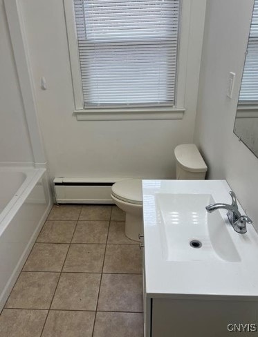 bathroom featuring vanity, a baseboard heating unit, toilet, a bath, and tile patterned floors