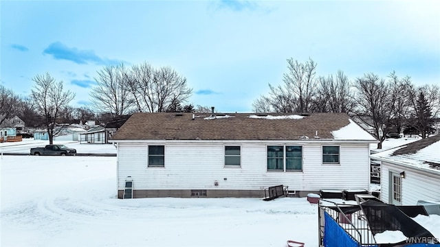 view of snow covered rear of property