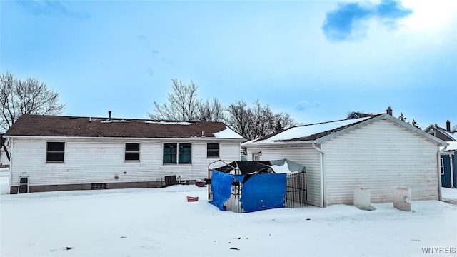 view of snow covered rear of property