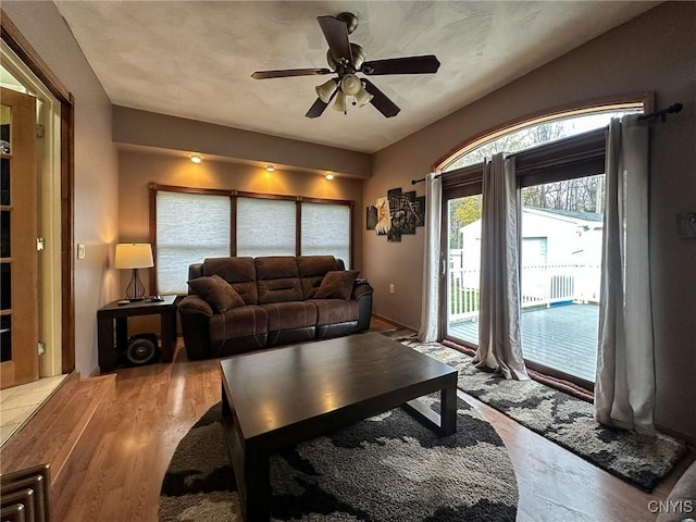 living room with ceiling fan and light hardwood / wood-style floors