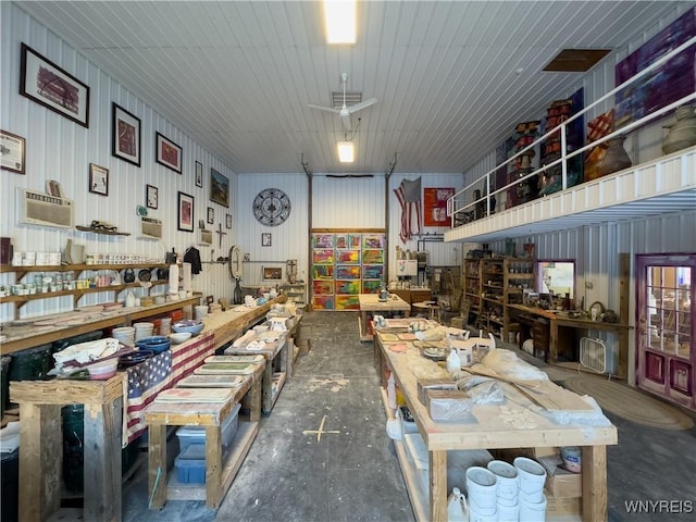 miscellaneous room with a wall unit AC and a workshop area