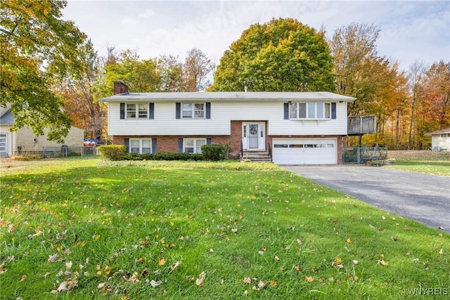 split foyer home with a garage and a front lawn