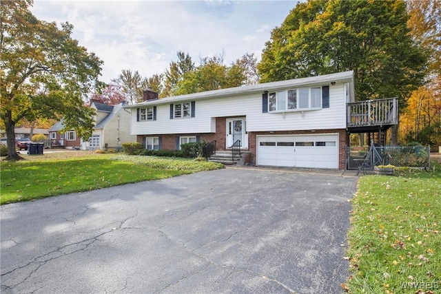 bi-level home with a garage and a front lawn