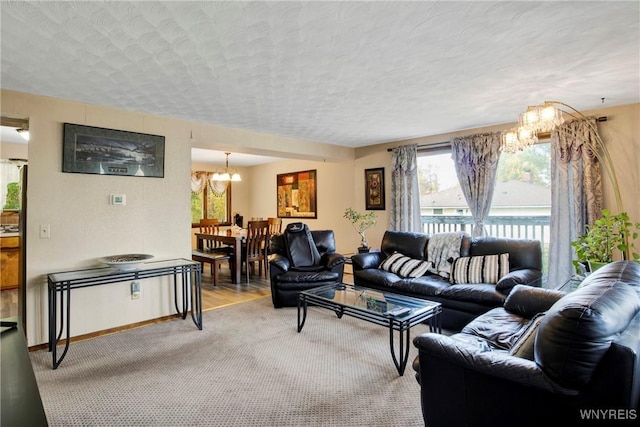 carpeted living room with a textured ceiling and an inviting chandelier