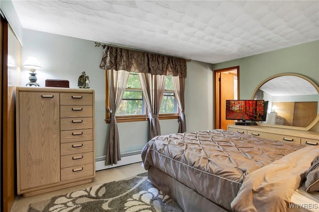 bedroom featuring a baseboard heating unit