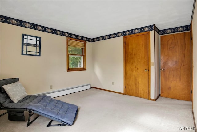 living area with light carpet and baseboard heating