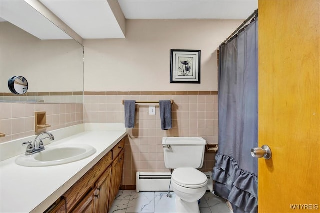 bathroom featuring vanity, a baseboard heating unit, toilet, and tile walls