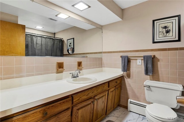 bathroom with vanity, a baseboard heating unit, tile walls, and toilet