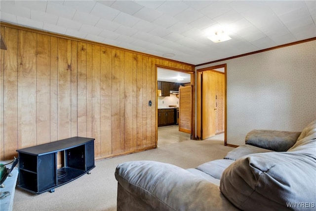 living room with crown molding and light colored carpet