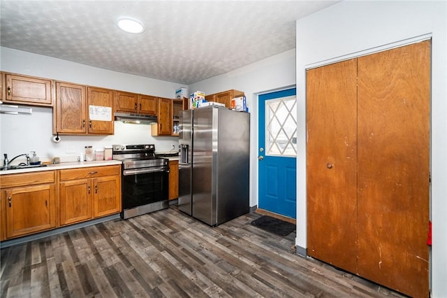 kitchen with sink, dark hardwood / wood-style floors, a textured ceiling, and appliances with stainless steel finishes