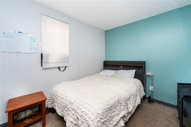 carpeted bedroom featuring a textured ceiling