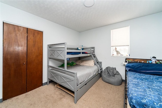 carpeted bedroom featuring a textured ceiling