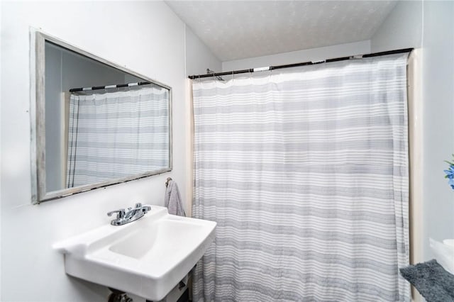 bathroom featuring sink and a textured ceiling