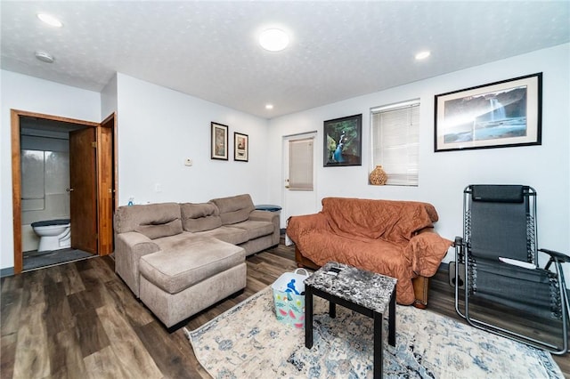 living room with hardwood / wood-style flooring and a textured ceiling